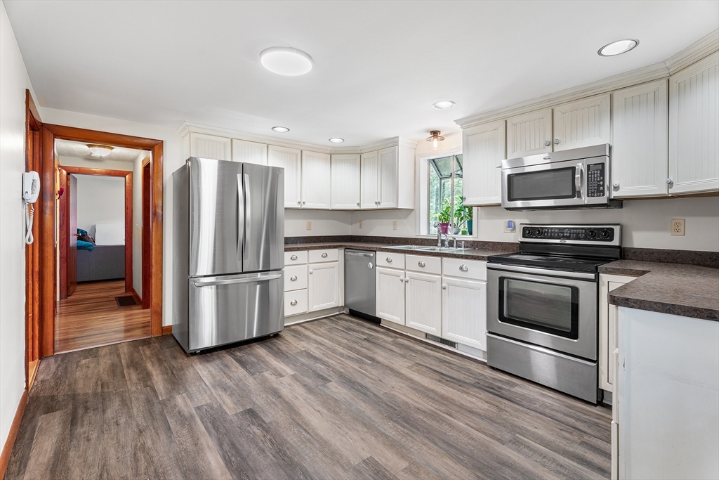 10 Mason Road Holden, MA 01522 - Photo 12 of 27 a kitchen with stainless steel appliances white cabinets and wooden floor