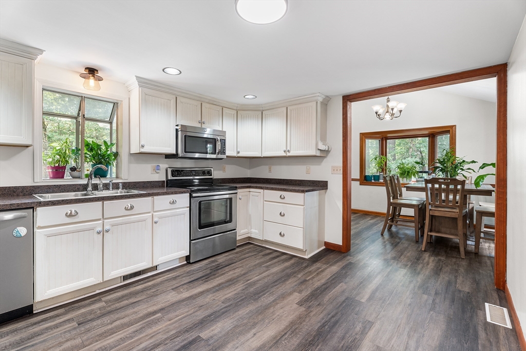 10 Mason Road Holden, MA 01522 - Photo 14 of 27 a kitchen with granite countertop a stove a sink and a refrigerator