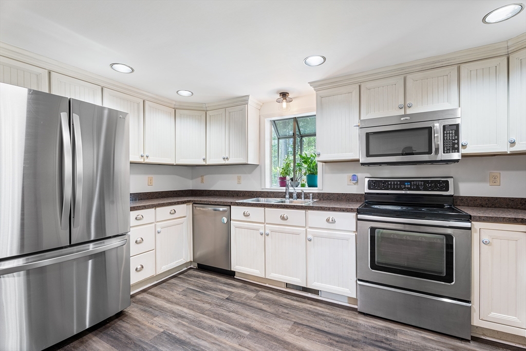 10 Mason Road Holden, MA 01522 - Photo 15 of 27 a kitchen with stainless steel appliances granite countertop a stove a refrigerator and a microwave