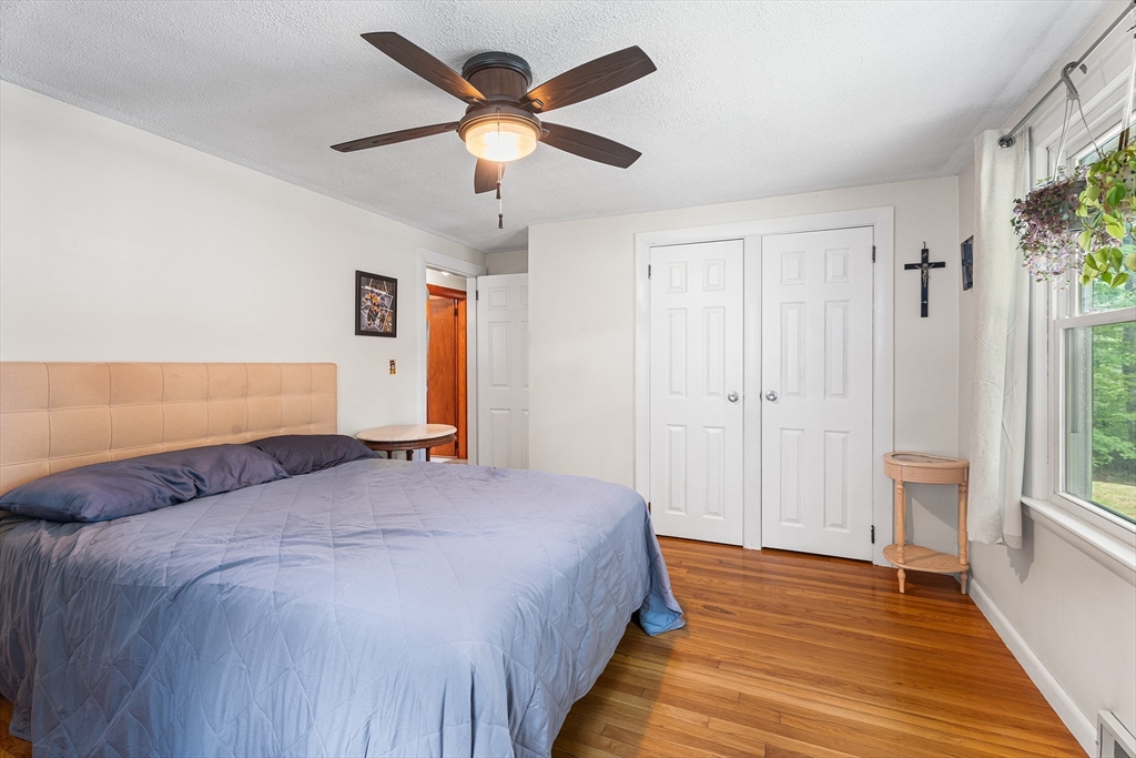 10 Mason Road Holden, MA 01522 - Photo 17 of 27 a bedroom with a large bed and a chandelier