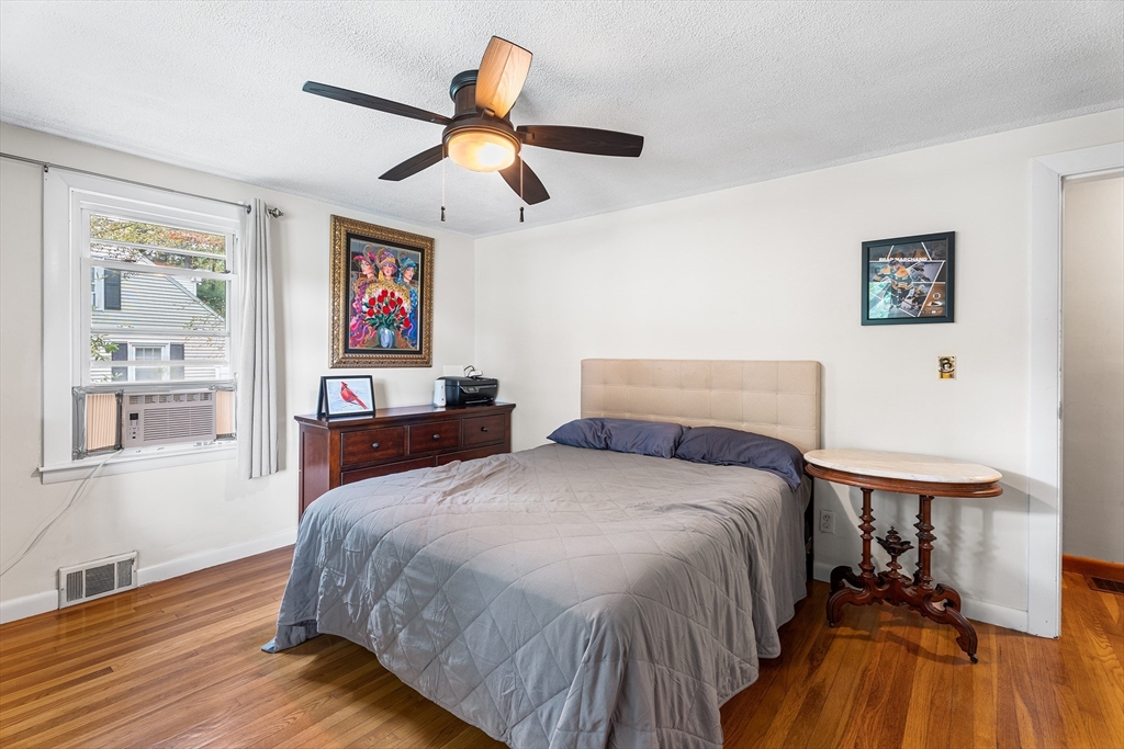 10 Mason Road Holden, MA 01522 - Photo 18 of 27 a spacious bedroom with a bed and a chandelier