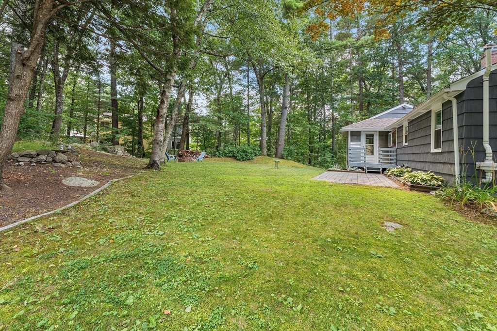10 Mason Road Holden, MA 01522 - Photo 23 of 27 a backyard of a house with large trees and outdoor seating