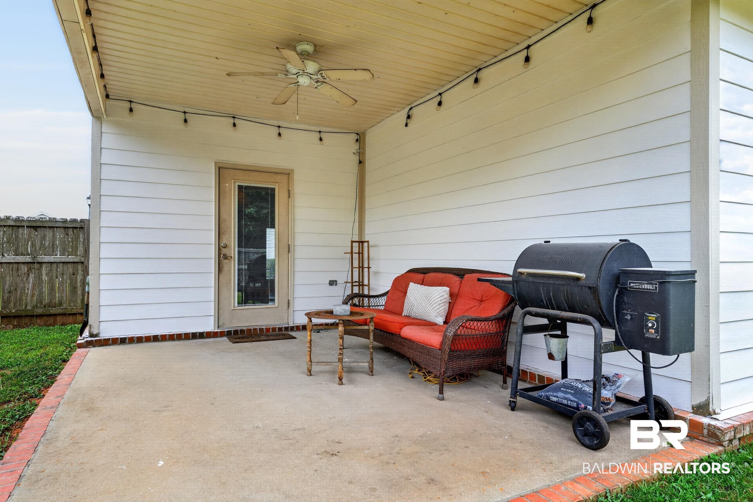 17419 Lewis Smith Drive Foley, AL 36535 - Photo 35 of 38 Covered concrete patio with white siding, brick trim, and a ceiling fan