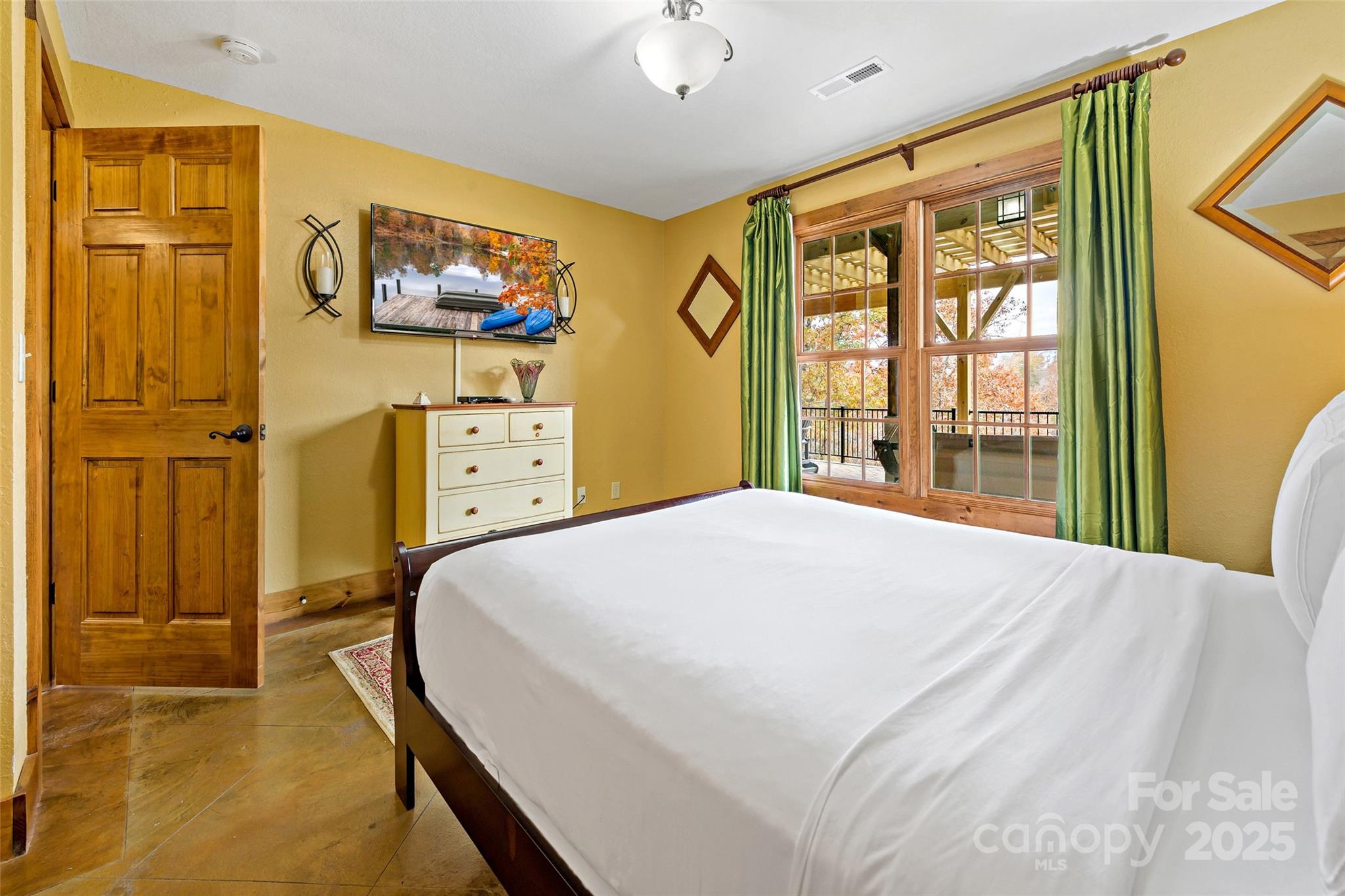 1237 South Cove Road Mill Spring, NC 28756 - Photo 25 of 44 a bedroom with a bed dresser and a window