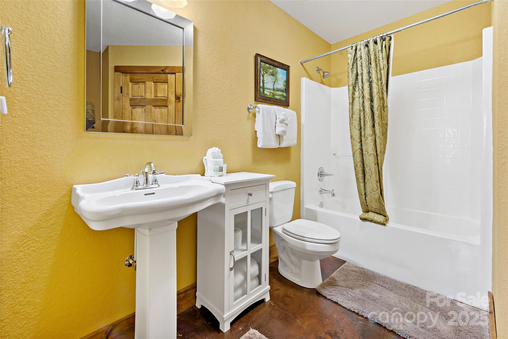 1237 South Cove Road Mill Spring, NC 28756 - Photo 31 of 44 a bathroom with a sink a toilet and shower curtain