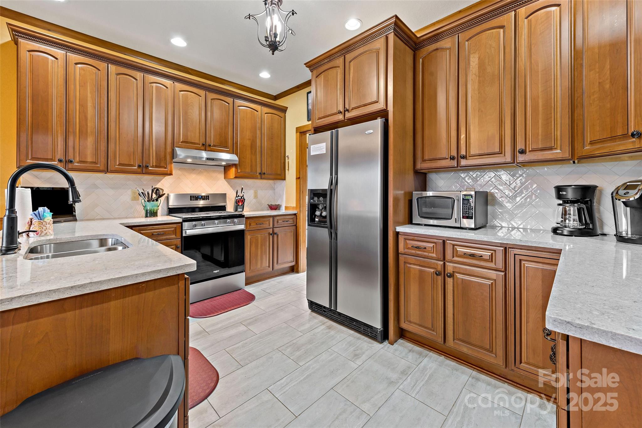 1237 South Cove Road Mill Spring, NC 28756 - Photo 8 of 44 a kitchen with stainless steel appliances granite countertop a refrigerator a sink dishwasher a stove with wooden cabinets and floor