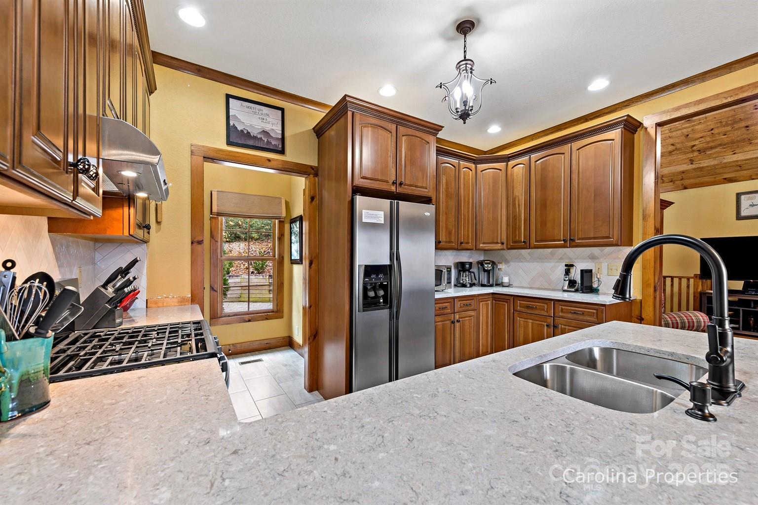 1237 South Cove Road Mill Spring, NC 28756 - Photo 9 of 44 a kitchen with stainless steel appliances granite countertop a sink refrigerator and cabinets