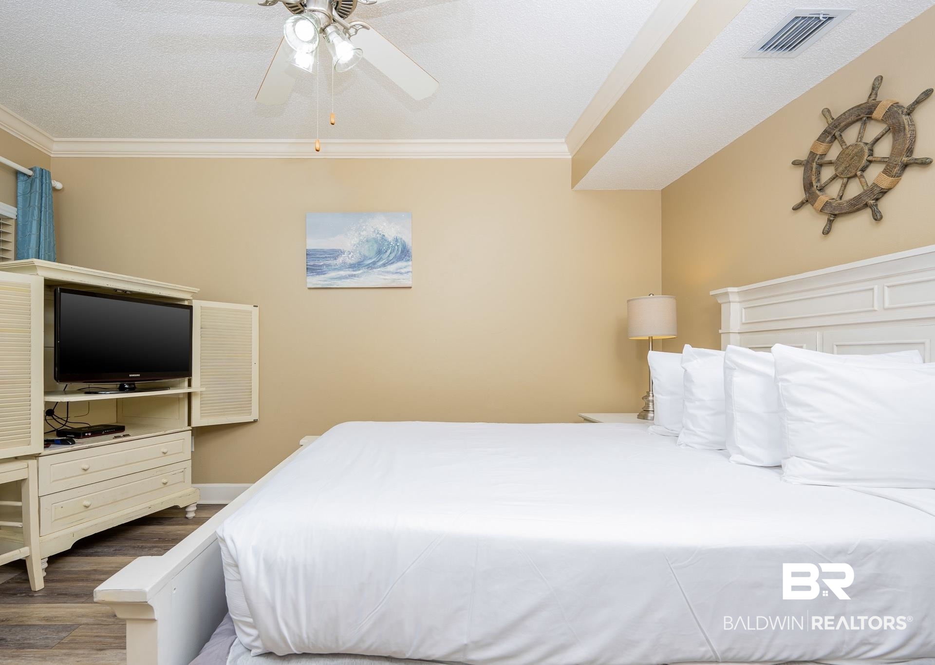 27580 Canal Road, Unit 1429 Orange Beach, AL 36561 - Photo 13 of 45 Bedroom featuring crown molding, a ceiling fan, wood finished floors, and a textured ceiling