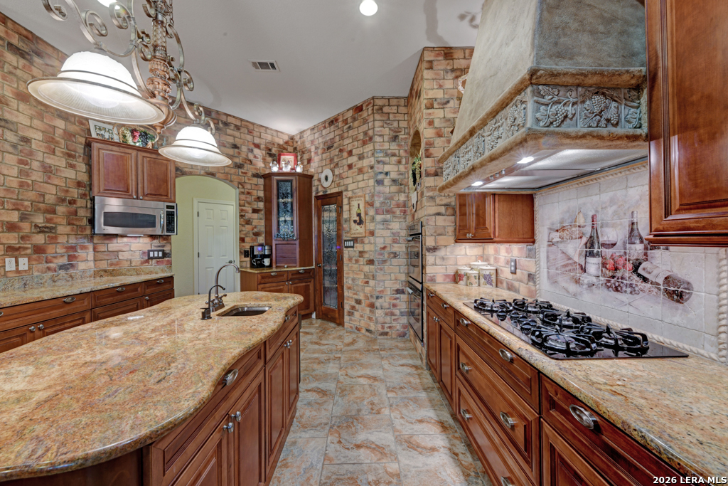 1700 Frontier Spring Branch, TX 78070 - Photo 27 of 74 a kitchen with stainless steel appliances granite countertop a stove a sink dishwasher and cabinets