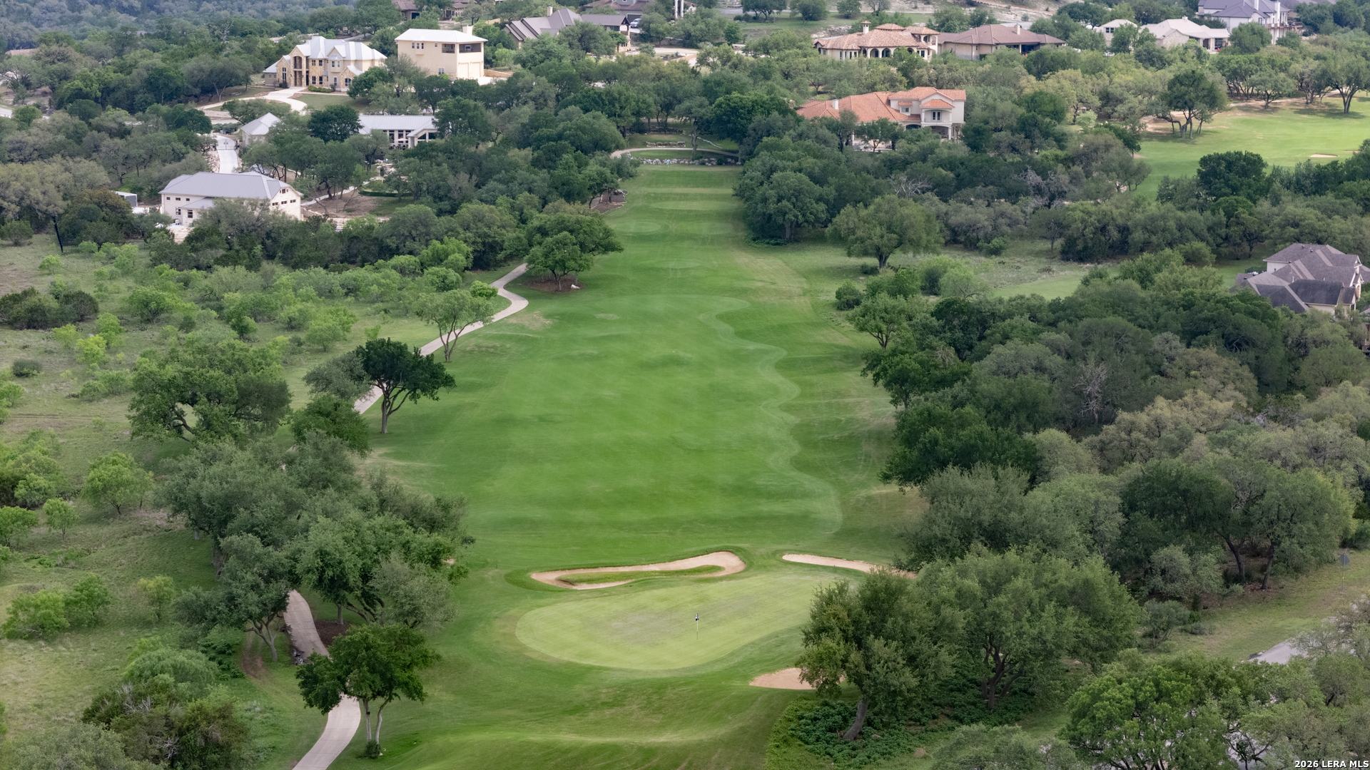 1700 Frontier Spring Branch, TX 78070 - Photo 72 of 74 an aerial view of green landscape with trees houses and mountain view