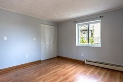22 Irving Street, Unit 8 Everett, MA 02149 - Photo 12 of 18 a view of an empty room with wooden floor and a window