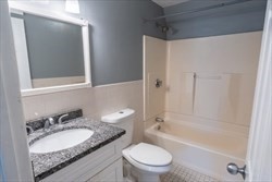22 Irving Street, Unit 8 Everett, MA 02149 - Photo 13 of 18 a bathroom with a granite countertop sink toilet and shower