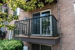 22 Irving Street, Unit 8 Everett, MA 02149 - Photo 16 of 18 a view of a house with a small yard and plants
