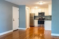 22 Irving Street, Unit 8 Everett, MA 02149 - Photo 6 of 18 a kitchen with stainless steel appliances a refrigerator and a stove top oven
