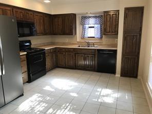 3104 Timber Ridge Grapevine, TX 76051 - Photo 3 of 12 a kitchen with stainless steel appliances granite countertop a refrigerator and a sink