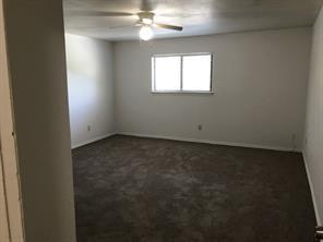 3104 Timber Ridge Grapevine, TX 76051 - Photo 6 of 12 an empty room with windows and chandelier fan