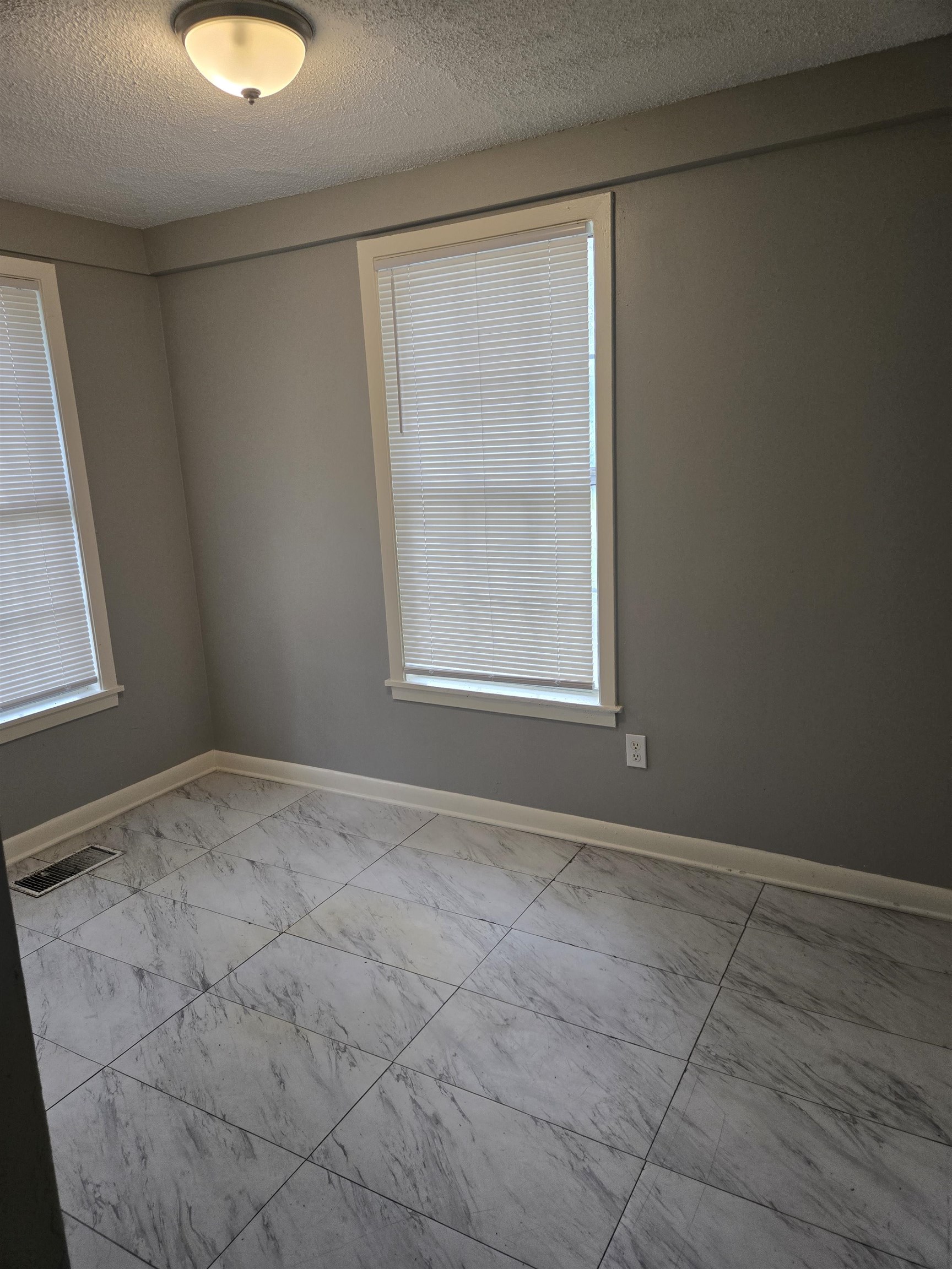1772 Carlyle Road Memphis, TN 38127 - Photo 11 of 14 Empty room featuring marble look tiles, a textured ceiling, and baseboards