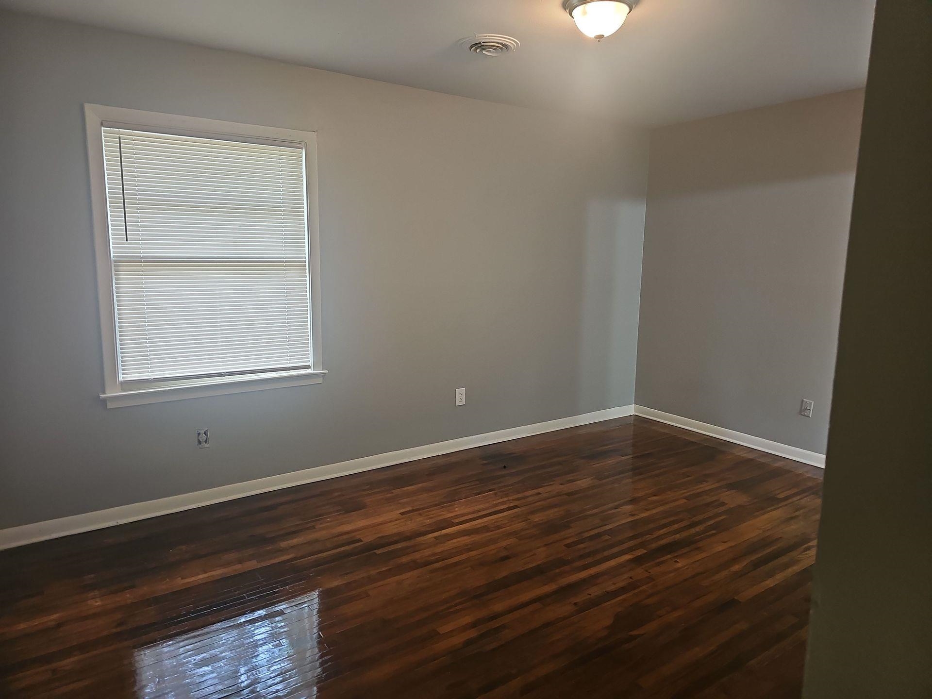 1772 Carlyle Road Memphis, TN 38127 - Photo 5 of 14 Empty room featuring dark wood-type flooring and baseboards