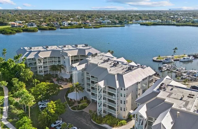 an aerial view of a house with outdoor space and lake view