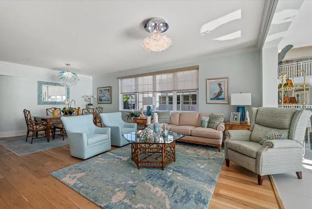 a spacious bedroom with a bed and a chandelier
