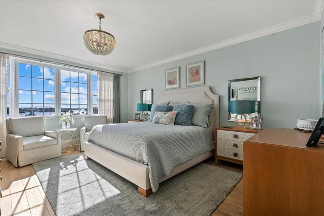 a large bedroom with a bed and a window