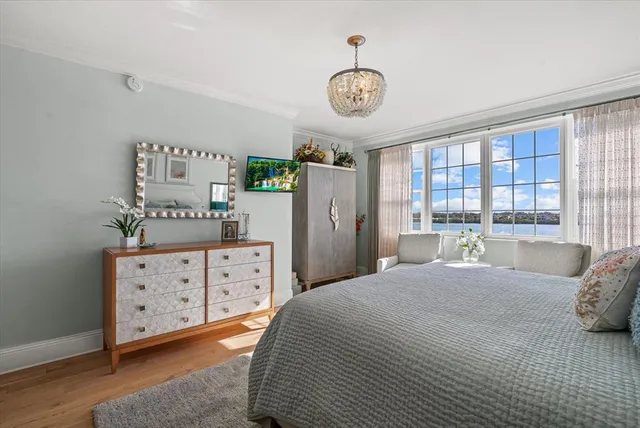 a bathroom with a granite countertop sink a toilet a large mirror a vanity and shower