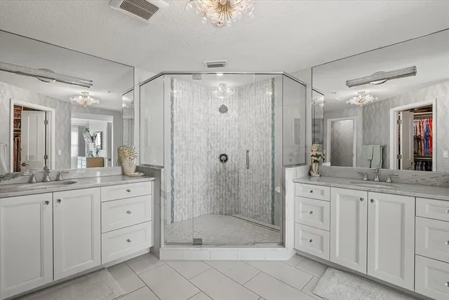 a living room with furniture a chandelier and a window