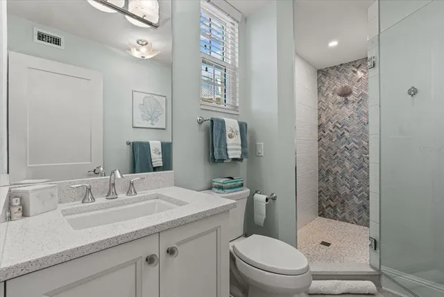 a kitchen with stainless steel appliances granite countertop a refrigerator a stove and a wooden floors