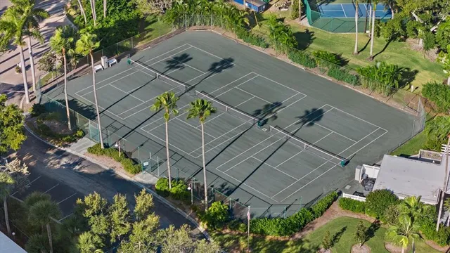 a kitchen with granite countertop a refrigerator a stove a sink and dishwasher with wooden floor