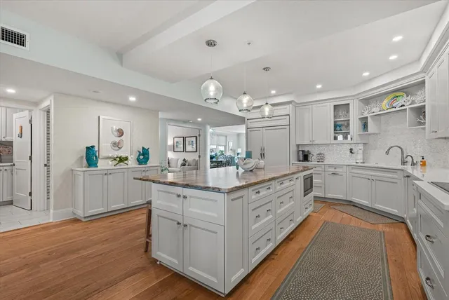 a dining room with furniture a rug and wooden floor