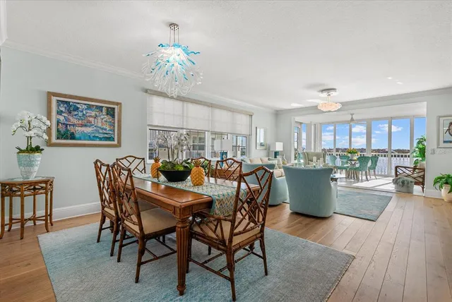 a living room with furniture large wooden floor and a table