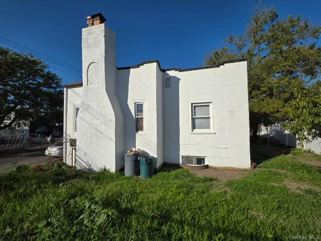 a view of a back yard with potted plants