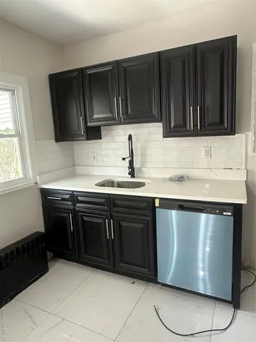 a kitchen with granite countertop cabinets and window