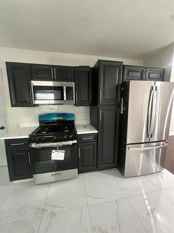 a kitchen with a stove and a refrigerator