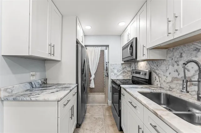 a kitchen with a sink stove and cabinets