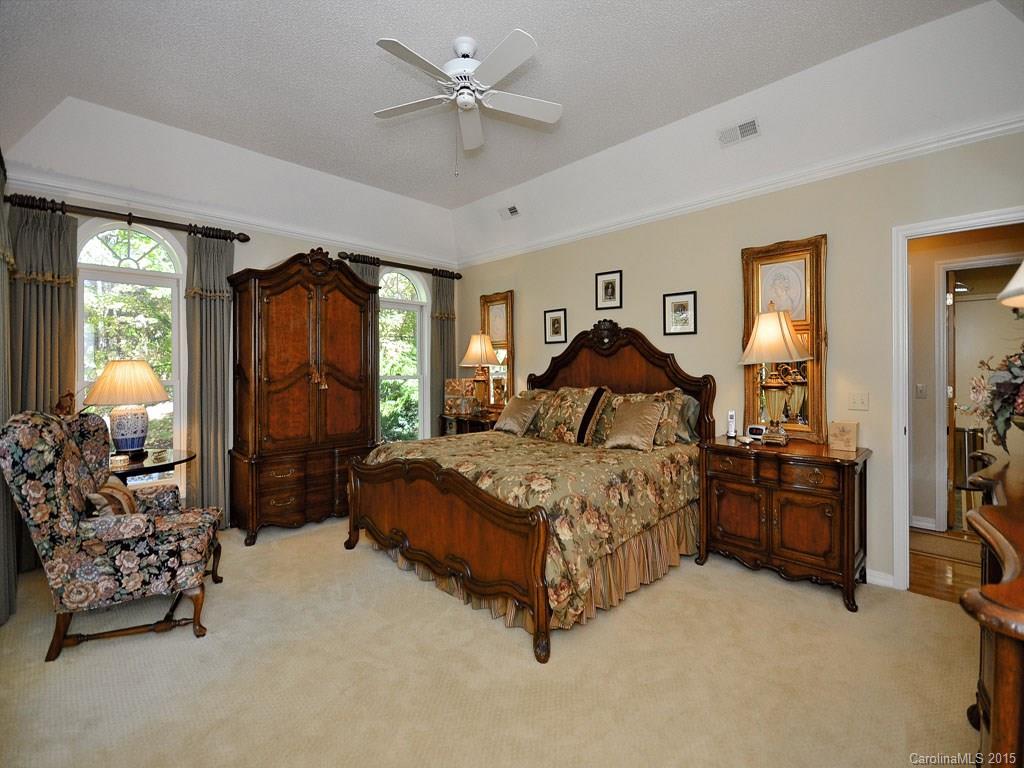 630 Parrish Farm Road Waynesville, NC 28786 - Photo 8 of 24 a bedroom with a bed and a chandelier