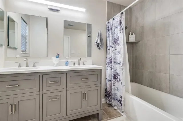 a bathroom with a bathtub a sink and a shower