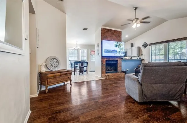 a living room with furniture and a wooden floor