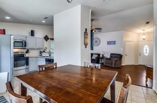 a kitchen with kitchen island a stove and a refrigerator