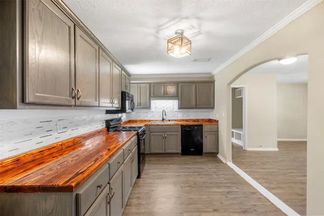 a kitchen with stainless steel appliances granite countertop a sink and cabinets