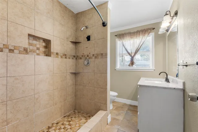 a bathroom with a sink toilet and shower