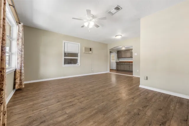 wooden floor in an empty room with a window