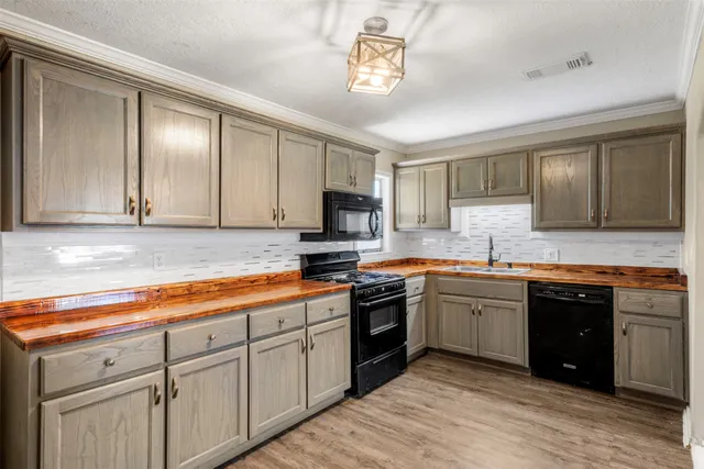 a kitchen with stainless steel appliances granite countertop a sink and cabinets