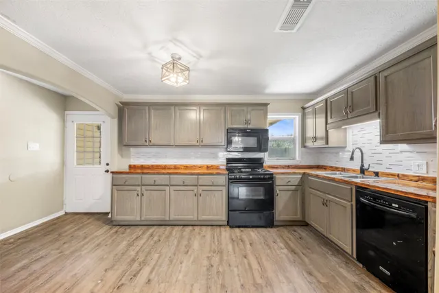 a kitchen with stainless steel appliances granite countertop a sink and stove top oven