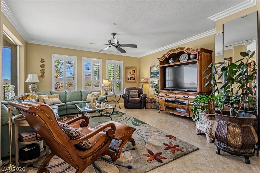 2555 Hampton Road, Unit 3308 Henderson, NV 89052 - Photo 9 of 65 Natural light floods this living room featuring tile flooring, a refreshing ceiling fan, and crown molding.