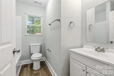 a white toilet sitting next to a bathroom sink