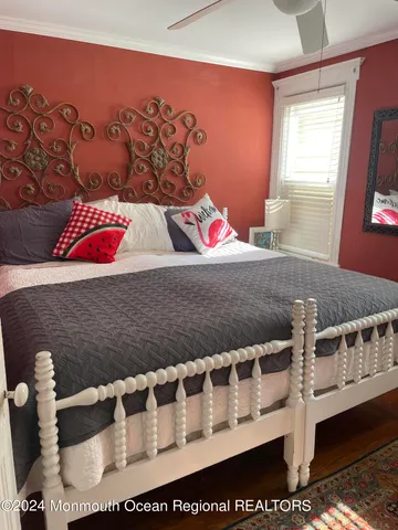 a bed sitting in a bedroom next to a window