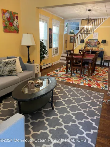 a living room with a couch and a chandelier