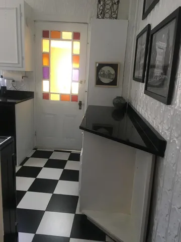 a kitchen with a sink a window and cabinets