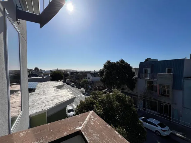 a view of roof deck with wooden floor and city view